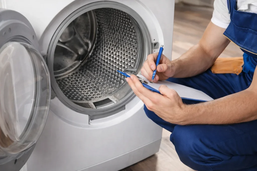 Technician checking dryer drum and interior components during repair service in Oshawa