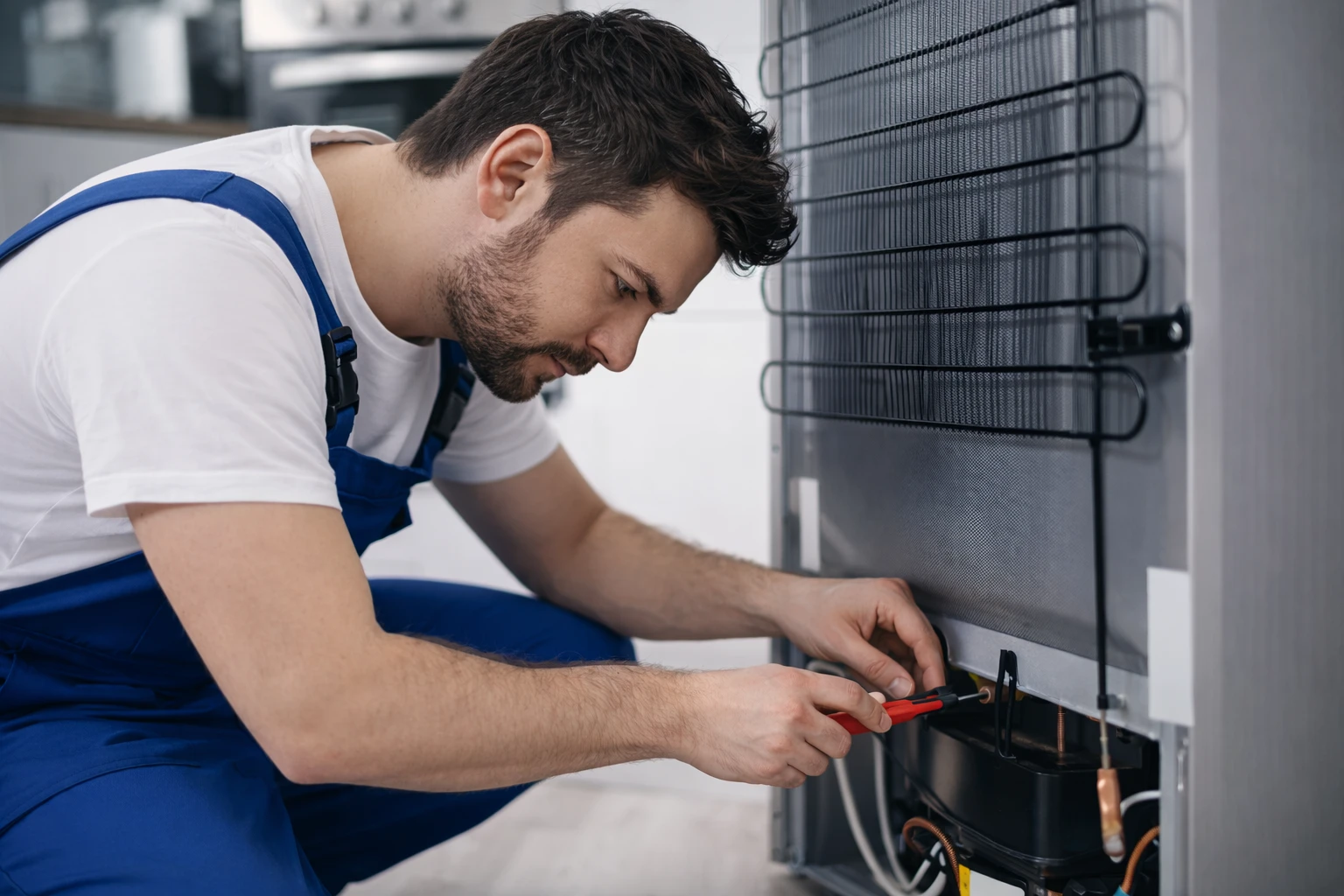 Technician repairing refrigerator compressor from the back in Oshawa